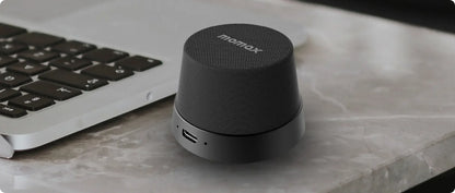 Tech stop MOMAX 1-Vibe Go magnetic wireless speaker and phone stand with IPX6 waterproof protection, shown in the image.