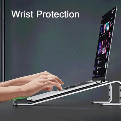 Tech Stop ergonomic aluminum laptop stand with wrist pad, portable design, ideal for comfortable workspace setup.