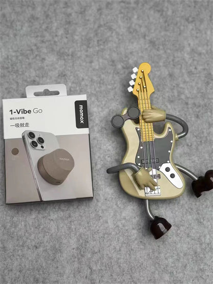 Tech stop MOMAX 1-Vibe Go magnetic wireless speaker and phone stand with IPX6 waterproof protection, shown in use.